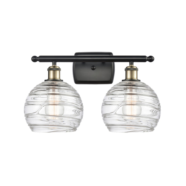 Deco Swirl Bath Vanity Light shown in the Black Antique Brass finish with a Clear shade