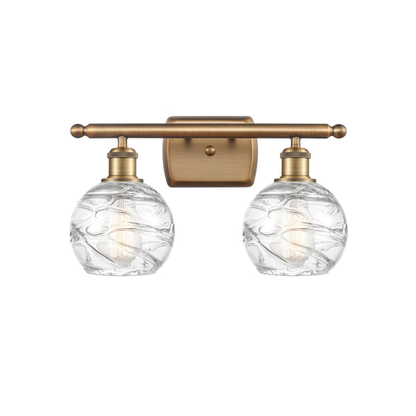 Deco Swirl Bath Vanity Light shown in the Brushed Brass finish with a Clear shade