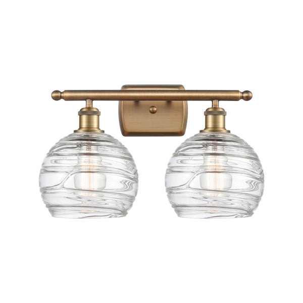 Deco Swirl Bath Vanity Light shown in the Brushed Brass finish with a Clear shade