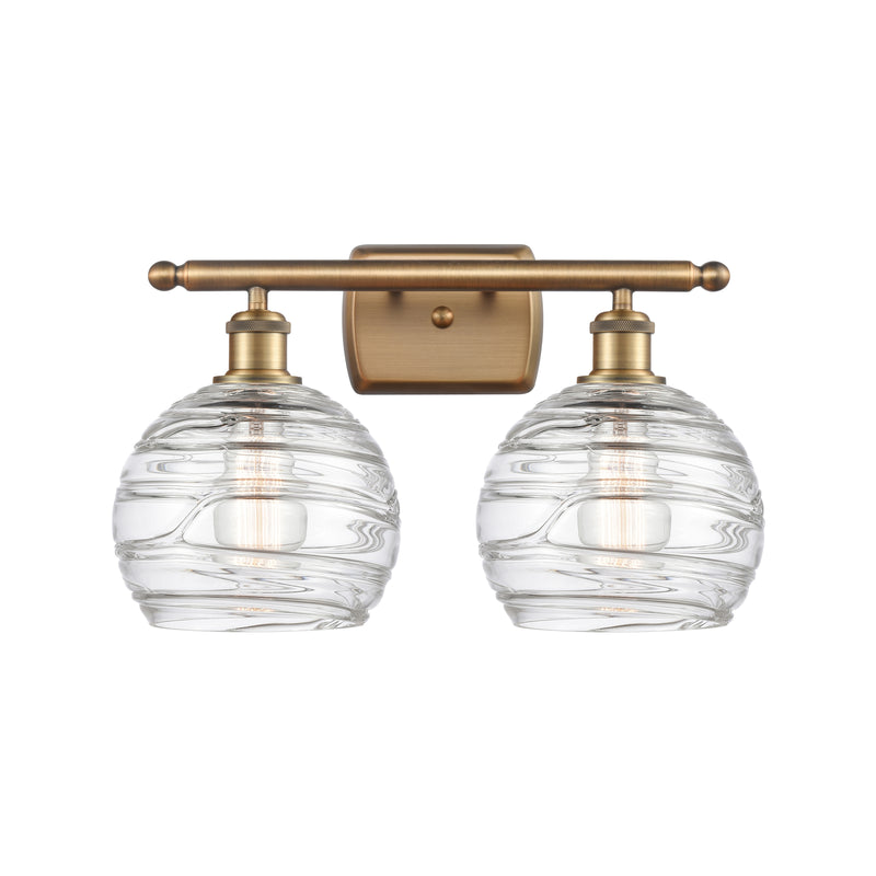 Deco Swirl Bath Vanity Light shown in the Brushed Brass finish with a Clear shade
