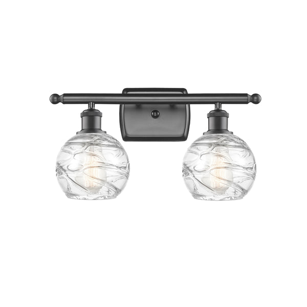 Deco Swirl Bath Vanity Light shown in the Oil Rubbed Bronze finish with a Clear shade