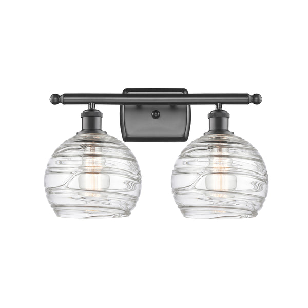 Deco Swirl Bath Vanity Light shown in the Oil Rubbed Bronze finish with a Clear shade