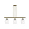 Candor Island Light shown in the Antique Brass finish with a Clear Waterglass shade