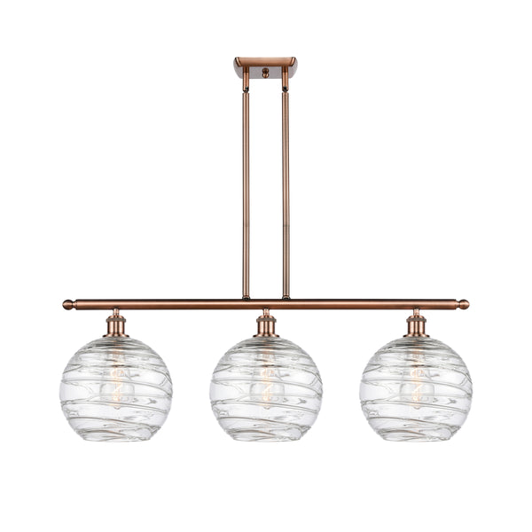 Deco Swirl Island Light shown in the Antique Copper finish with a Clear shade
