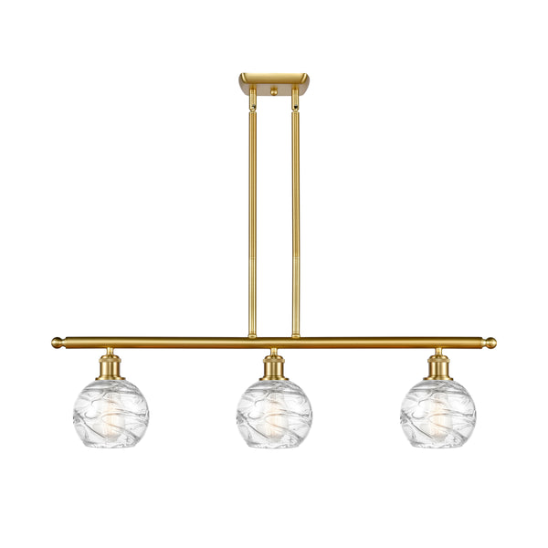 Deco Swirl Island Light shown in the Satin Gold finish with a Clear shade