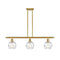 Deco Swirl Island Light shown in the Satin Gold finish with a Clear shade
