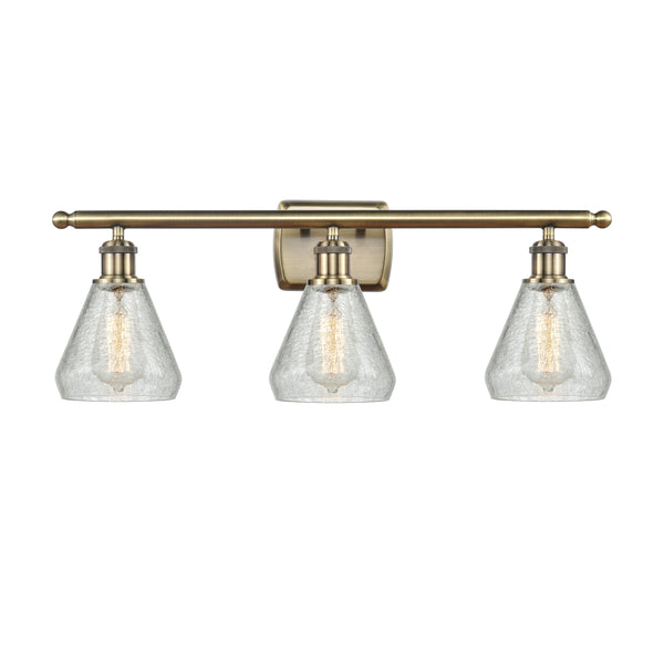 Conesus Bath Vanity Light shown in the Antique Brass finish with a Clear Crackle shade
