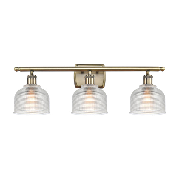 Dayton Bath Vanity Light shown in the Antique Brass finish with a Clear shade