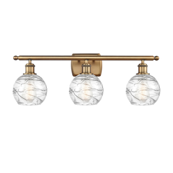 Deco Swirl Bath Vanity Light shown in the Brushed Brass finish with a Clear shade