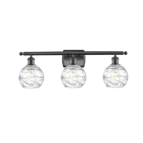 Deco Swirl Bath Vanity Light shown in the Oil Rubbed Bronze finish with a Clear shade