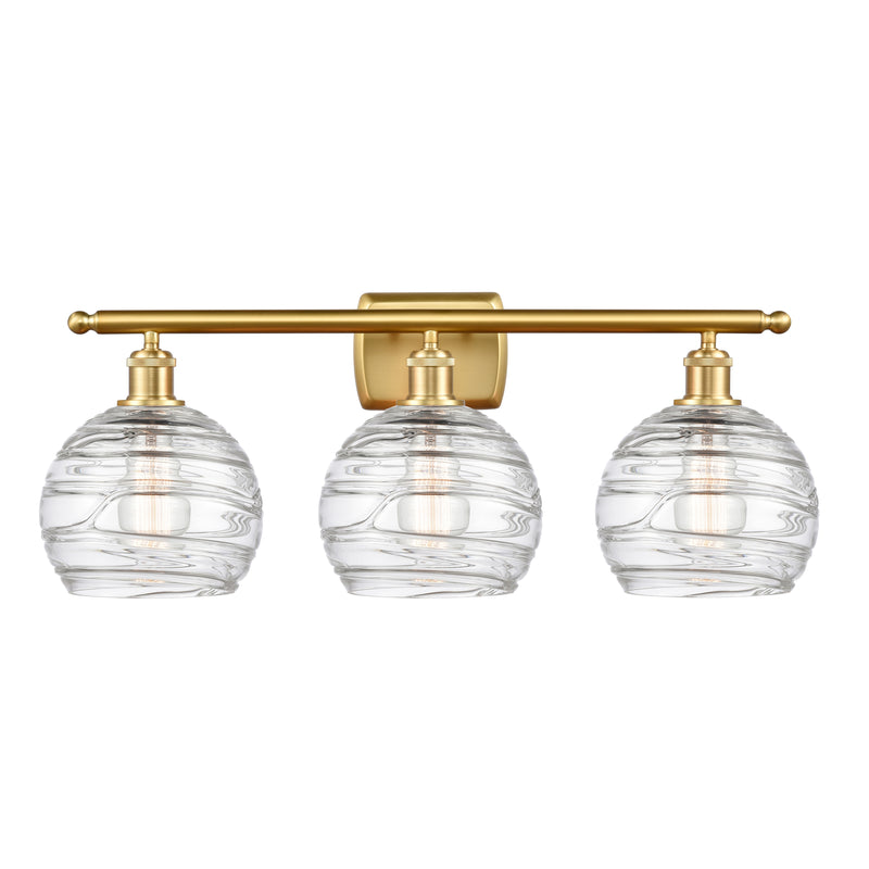Deco Swirl Bath Vanity Light shown in the Satin Gold finish with a Clear shade