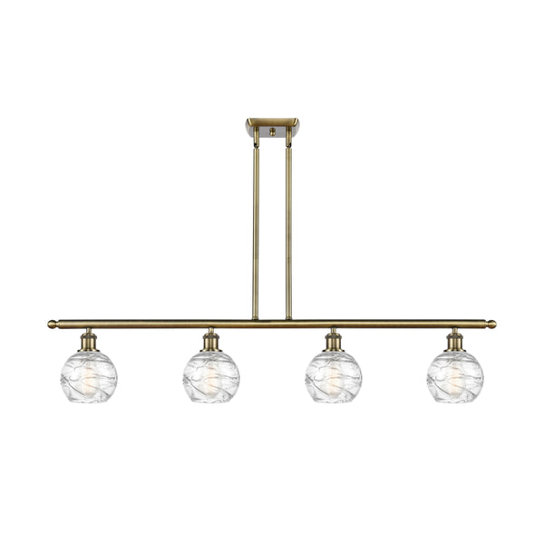 Deco Swirl Island Light shown in the Antique Brass finish with a Clear shade