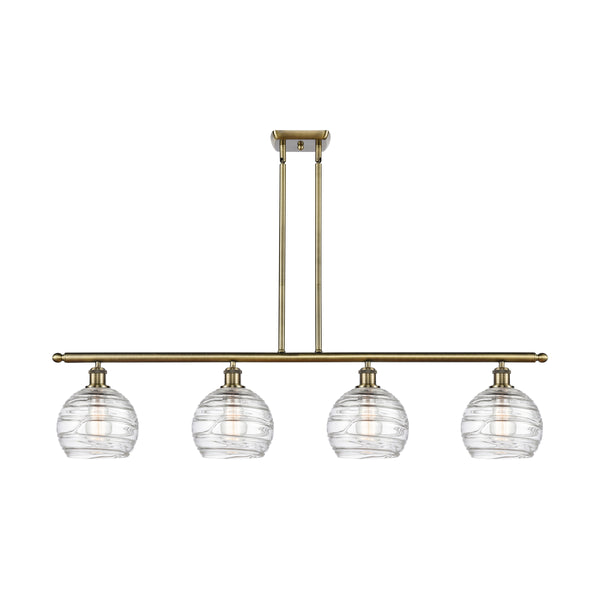 Deco Swirl Island Light shown in the Antique Brass finish with a Clear shade