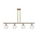 Deco Swirl Island Light shown in the Brushed Brass finish with a Clear shade