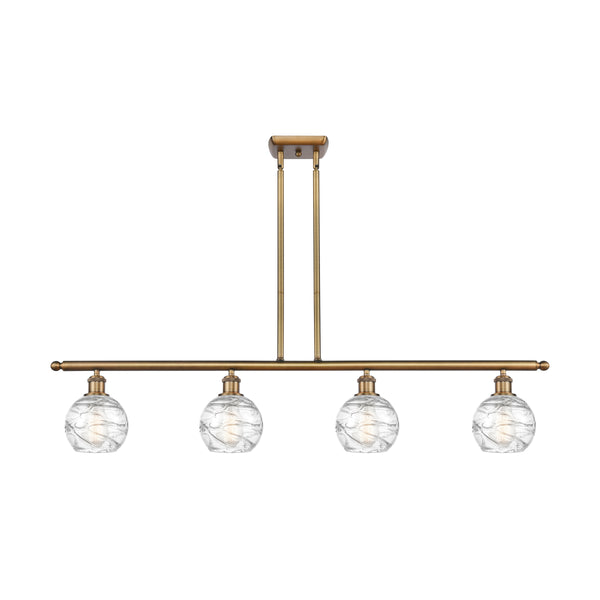 Deco Swirl Island Light shown in the Brushed Brass finish with a Clear shade