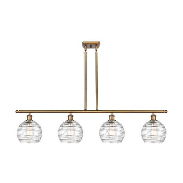 Deco Swirl Island Light shown in the Brushed Brass finish with a Clear shade