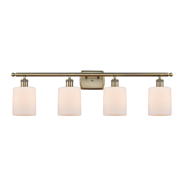 Cobbleskill Bath Vanity Light shown in the Antique Brass finish with a Matte White shade