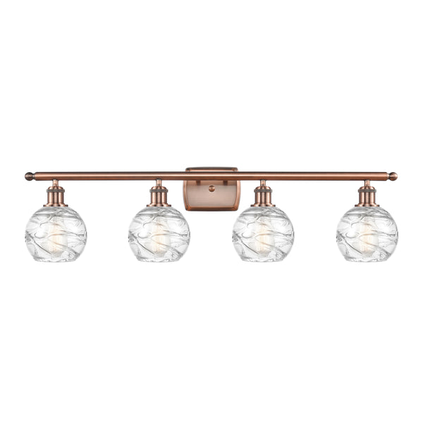 Deco Swirl Bath Vanity Light shown in the Antique Copper finish with a Clear shade