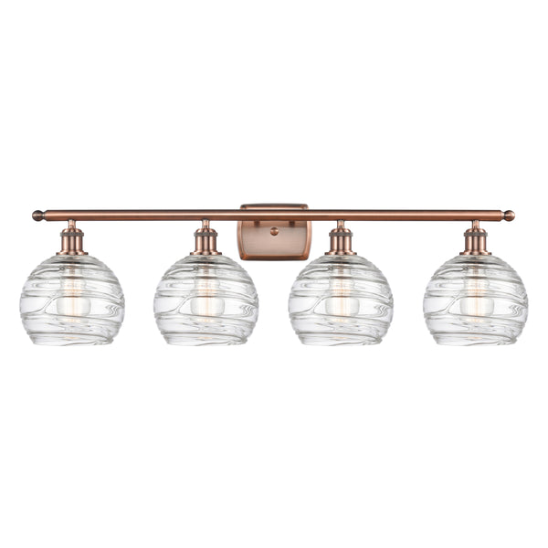 Deco Swirl Bath Vanity Light shown in the Antique Copper finish with a Clear shade