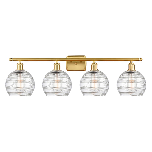 Deco Swirl Bath Vanity Light shown in the Satin Gold finish with a Clear shade