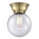Beacon Flush Mount shown in the Antique Brass finish with a Seedy shade