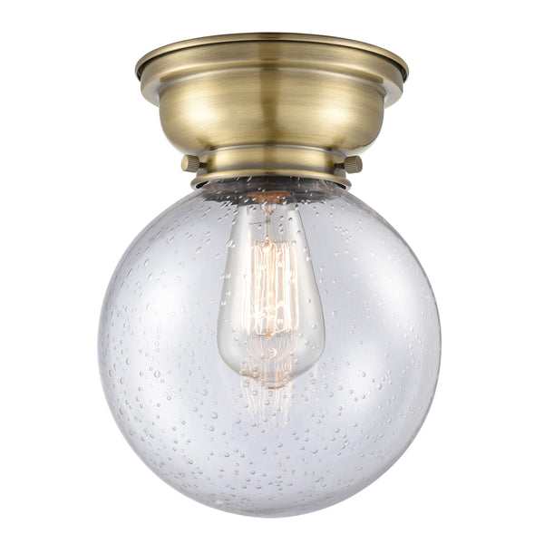 Beacon Flush Mount shown in the Antique Brass finish with a Seedy shade