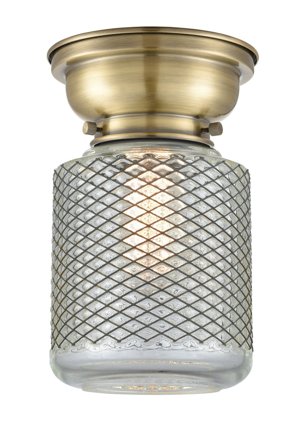 Stanton Flush Mount shown in the Antique Brass finish with a Clear Wire Mesh shade