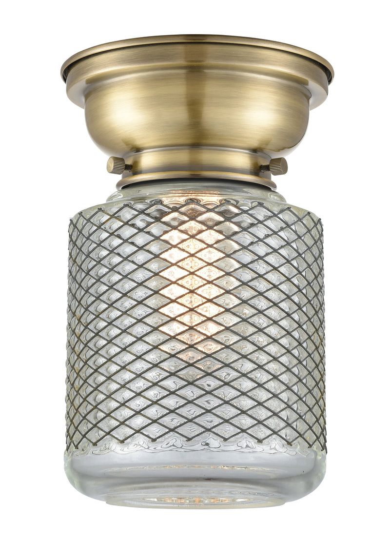 Stanton Flush Mount shown in the Antique Brass finish with a Clear Wire Mesh shade