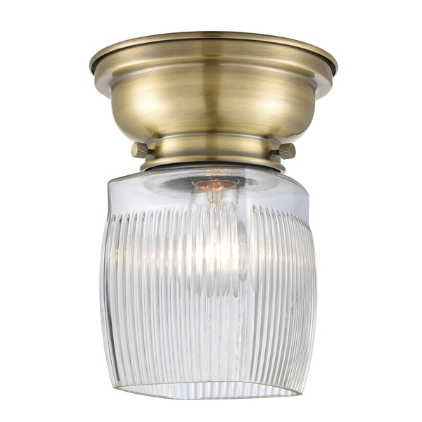 Colton Flush Mount shown in the Antique Brass finish with a Clear Halophane shade