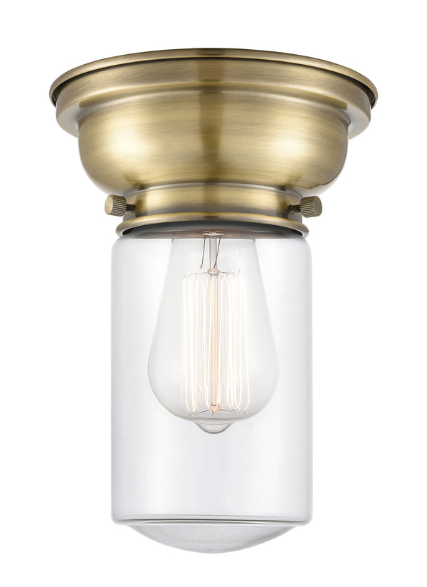 Dover Flush Mount shown in the Antique Brass finish with a Clear shade