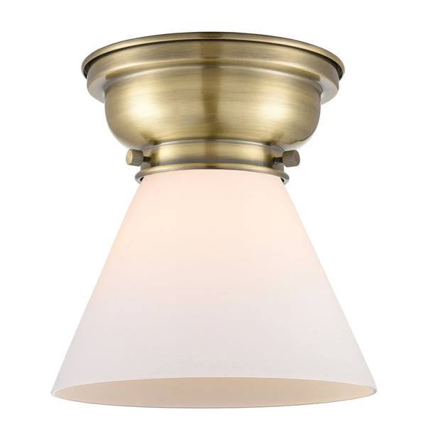 Cone Flush Mount shown in the Antique Brass finish with a Matte White shade