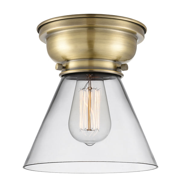 Cone Flush Mount shown in the Antique Brass finish with a Clear shade