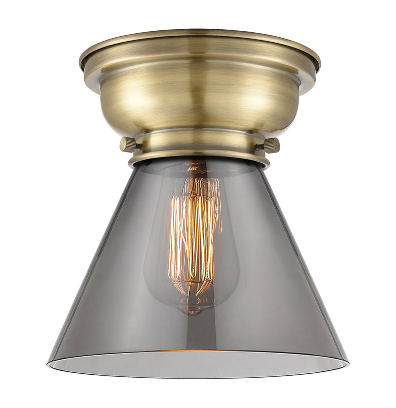 Cone Flush Mount shown in the Antique Brass finish with a Plated Smoke shade