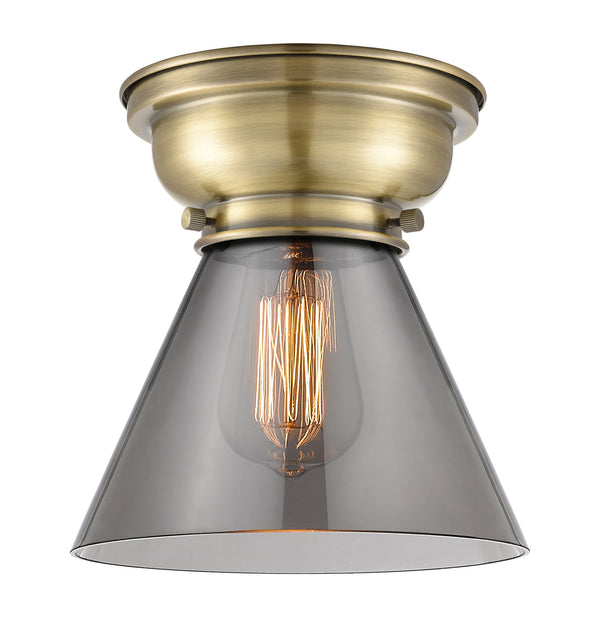 Cone Flush Mount shown in the Antique Brass finish with a Plated Smoke shade