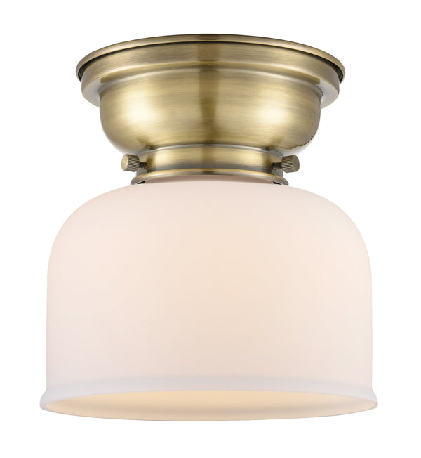 Bell Flush Mount shown in the Antique Brass finish with a Matte White shade
