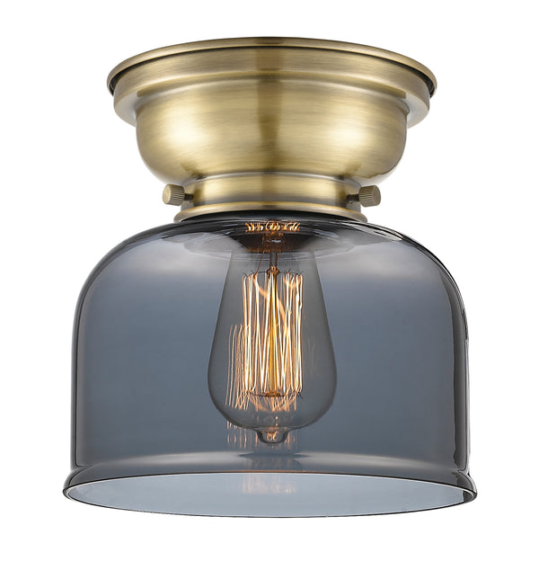 Bell Flush Mount shown in the Antique Brass finish with a Plated Smoke shade