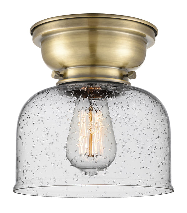 Bell Flush Mount shown in the Antique Brass finish with a Seedy shade