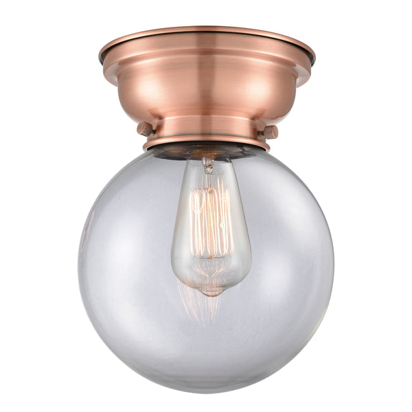 Beacon Flush Mount shown in the Antique Copper finish with a Clear shade