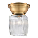 Colton Flush Mount shown in the Brushed Brass finish with a Clear Halophane shade