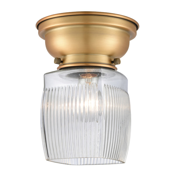 Colton Flush Mount shown in the Brushed Brass finish with a Clear Halophane shade