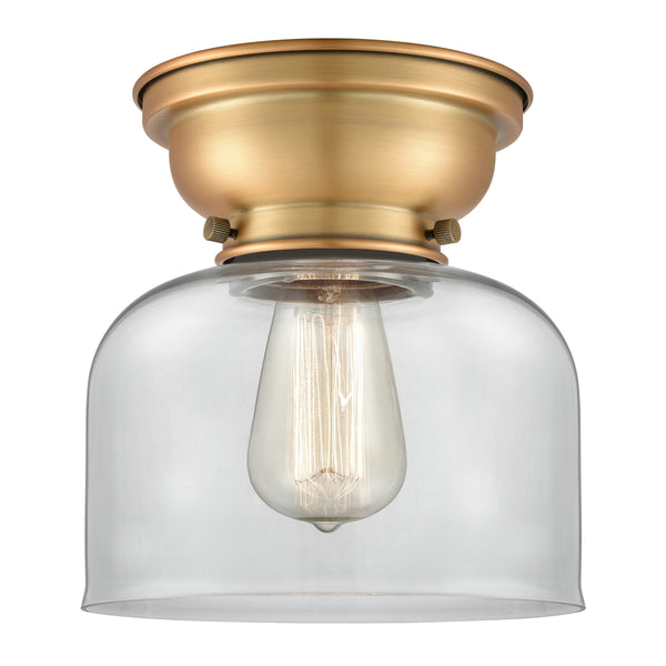 Bell Flush Mount shown in the Brushed Brass finish with a Clear shade