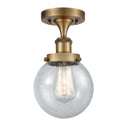 Beacon Semi-Flush Mount shown in the Brushed Brass finish with a Seedy shade