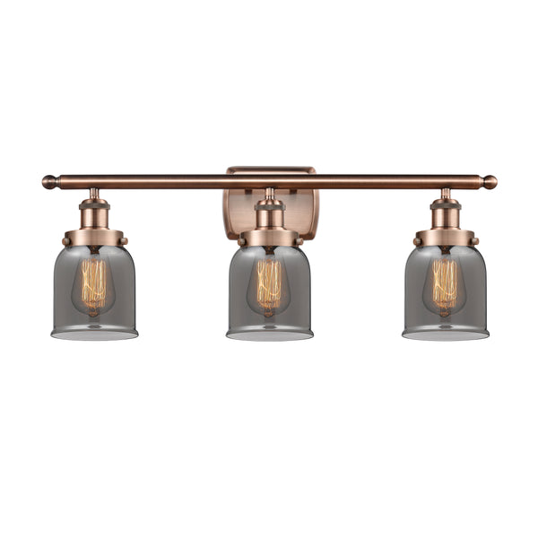 Bell Bath Vanity Light shown in the Antique Copper finish with a Plated Smoke shade