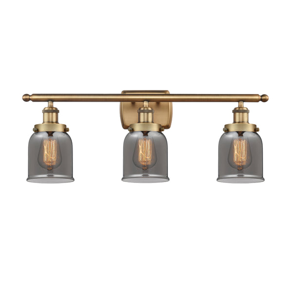 Bell Bath Vanity Light shown in the Brushed Brass finish with a Plated Smoke shade