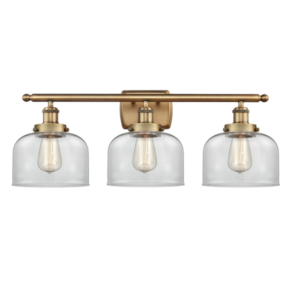 Bell Bath Vanity Light shown in the Brushed Brass finish with a Clear shade